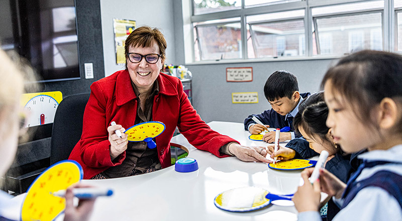 Dedicated teacher with students at St Margaret Mary's Catholic Primary Merrylands